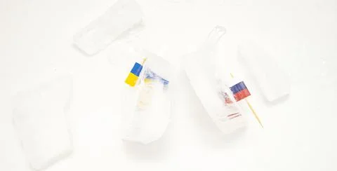 The split of two friendly countries. Two flags frozen in ice flags of Russia  Stock Photos
