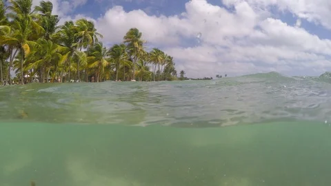 Split underwater view of Bois Jolan beach on a cloudy day. Guadeloupe, French we Stock Footage 105922674