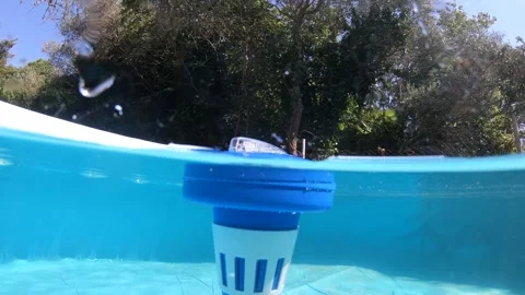 Split underwater view of chlorine dispenser in a swimming pool Video stock 303292070