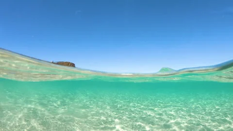 Split underwater view in La Pelosa beach Stock Footage 330192844