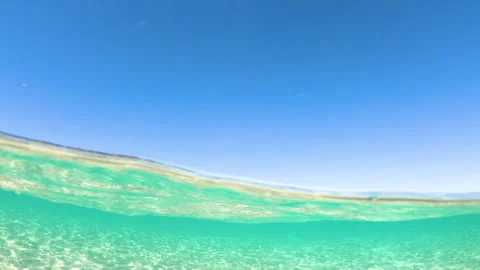 Split underwater view of La Pelosa beach with tower in Stintino slow motion Stock Footage 332775024