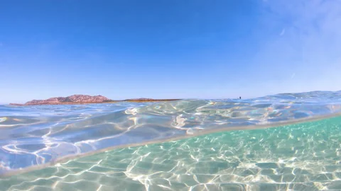 Split underwater view in La Pelosa beach Stock Footage 333121313
