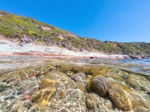 Split underwater view of La Speranza beach on a sunny day. Sardinia, Italy Stock Photos