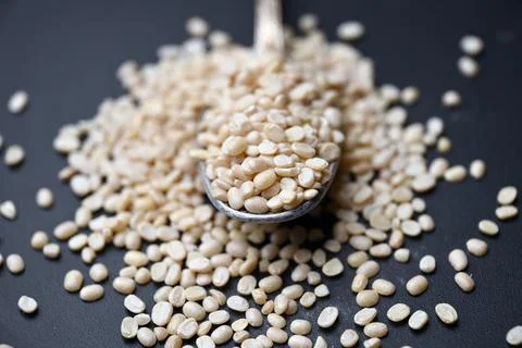 Split Urad Dal in Spoon Angled Top View with Defocus Background Macro Photo.. Stock Photos