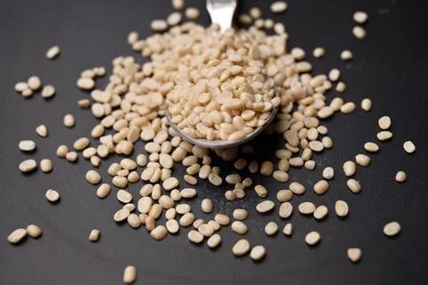 Split Urad Dal in Spoon Angled Top View with Defocus Background Macro Photo.. Stock Photos