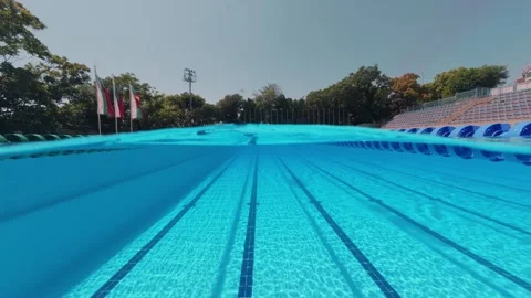 Split View Outdoor Swimming Pool Lanes with Swimmer in Distance Stock Footage 342020435
