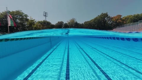 Split View Outdoor Swimming Pool Lanes with Swimmer in Distance Stock Footage 342020479