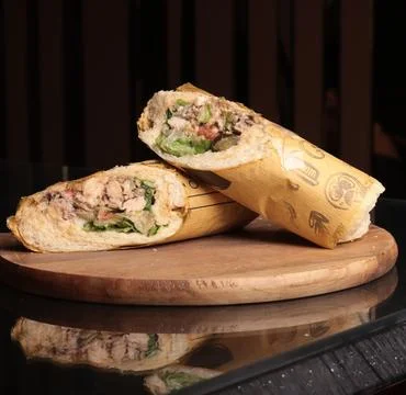 Split view of sandwich wraps filled with meat and vegetables Stock Photos