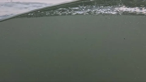 Split water level shot of ocean waves at sunset with slow motion flow bubbl.. Stock Footage 346101262