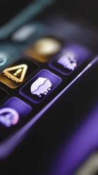 Split white shield glows on purple control tile Stock Photos