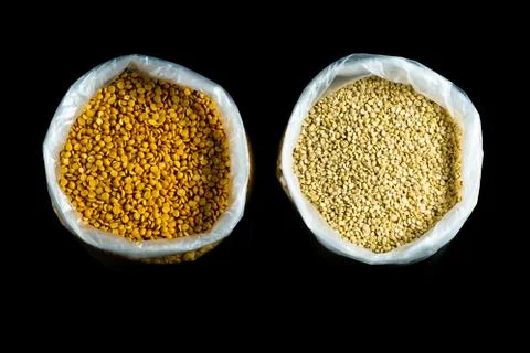 Split yellow gram and black gram in bags Stock Photos