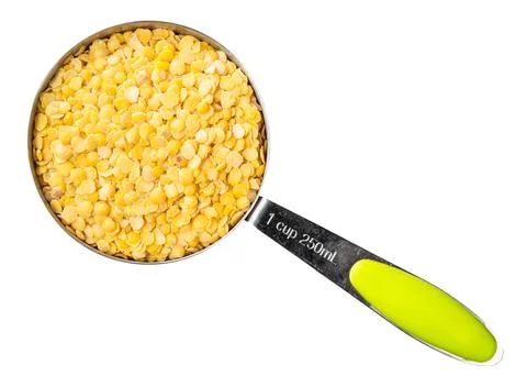 Split yellow lentils in measuring cup cutout Stock Photos
