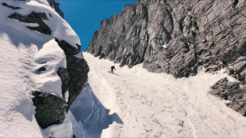 Splitboarder slow motion coming through chute Stock Footage 278907745