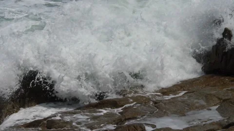 Splits waves against rocks in the sea Stock Footage 224051208