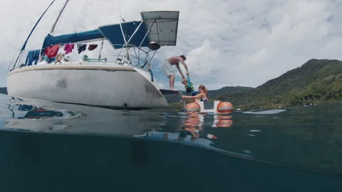 Splitted underwater view of the sailing boat with family with kids on it Stock Footage 341680840