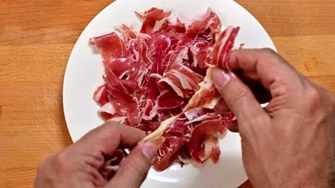 Splitting and serving the serrano ham Stock Footage 228221465
