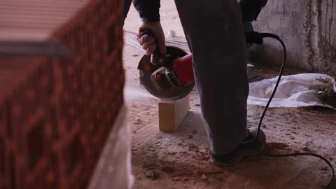 Splitting bricks with a grinder Stock Footage 309952285