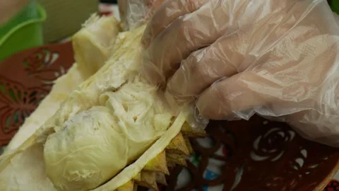 Splitting durian fruit with bare hand and opened it Stock Footage 273439131