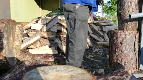 Splitting firewoods with log splitter, pan right Stock Footage 63125108