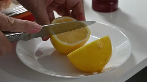 Splitting a lemon with a knife Stock Footage 217972859