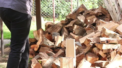 Splitting logs with an axe. Preparation for the winter Stock Footage 57276562