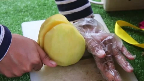 Splitting a mango using a knife close up Stock Footage 270347457