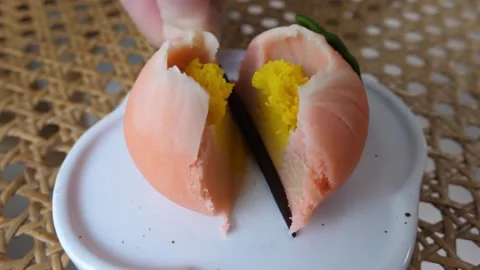Splitting Open a Peach Shaped Wagashi Mochi Dessert Stock Footage 345293669