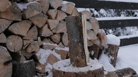 Splitting wood on the snowy winter day slowmotion hit Stock Footage