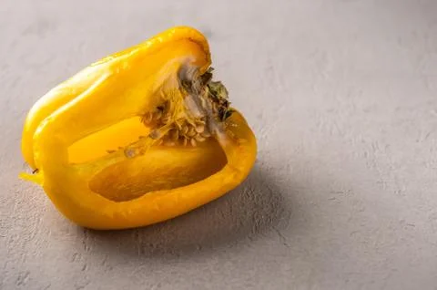 Spoiled bell pepper on a light background. Vegetables with mold. Improper Stock Photos