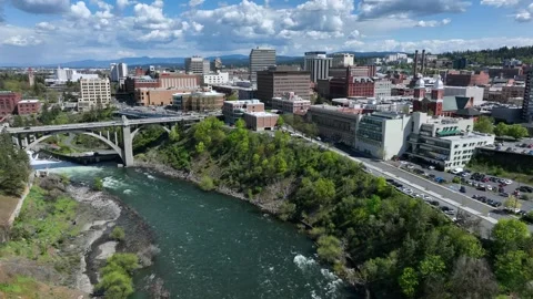 Spokane River flowing through downtown city with Monroe Street Bridge and Видео 335263879