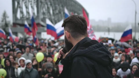 Spokesman on stage speaks via microphone with protesting strike crowd in Russia Stock Footage 164885352