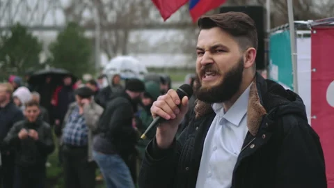 Spokesman on stage speaks via microphone with protesting strike crowd in Russia Stock Footage 166126295