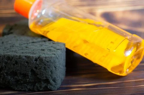 Sponge and detergent on the table Stock Photos