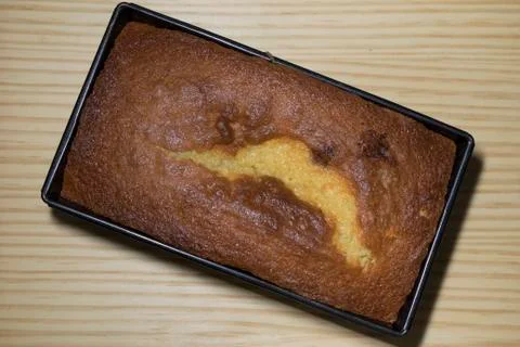 Sponge cake baked in a pan rectangular overhead view with wooden background Stock Photos