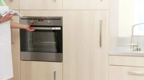 Sponge cake being removed from the oven and the edge being loosened Stock Footage 24638965