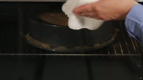 A sponge cake being tested with a wooden stick Stock-Footage 24671090