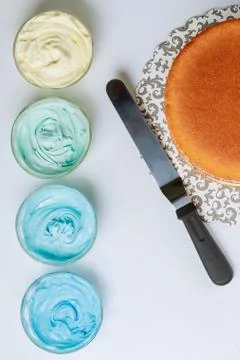 Sponge cake before decoration with blue icing. Stock Photos