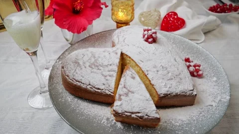 Sponge cake heart shaped on plate rotate. Champagne Valentines day. Slow motion Video stock 259396068