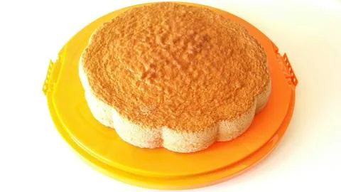 Sponge cake on orange tray Stock Photos