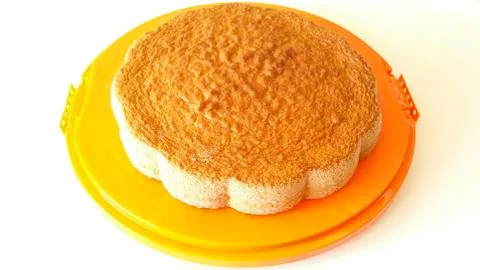 Sponge cake on orange tray Stock Photos