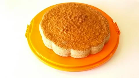 Sponge cake on orange tray Stock Photos