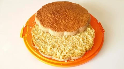 Sponge cake on orange tray Stock Photos