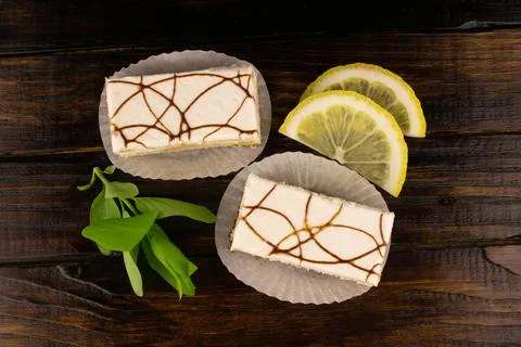 Sponge cake in white icing with lemon slices and fresh mint Stock Photos