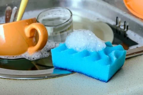 Sponge cleaning dishes 写真素材