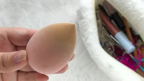The sponge is dirty, stained with foundation in hand Stock Footage 316286809
