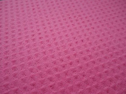 Sponge fibers sponge texture pattern surface close-up pink magenta background Foto stock