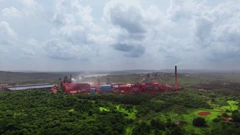 Sponge iron plant amid dense forest under a stormy monsoon sky Stock Footage 340866048