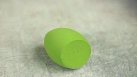 Sponge for makeup - rotates on a beautiful background. Cosmetics, makeup. Stock Footage 130346408