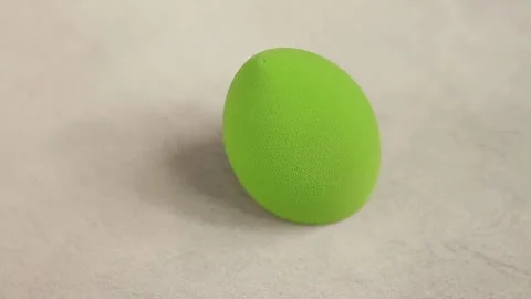 Sponge for makeup - rotates on a beautiful background. Cosmetics, makeup. Stock Footage 130346456