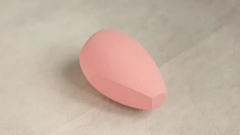 Sponge for makeup - rotates on a beautiful background. Cosmetics, makeup. Stock Footage 130346462